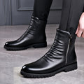 Men's black leather zip-side boots with treaded sole, on foot
