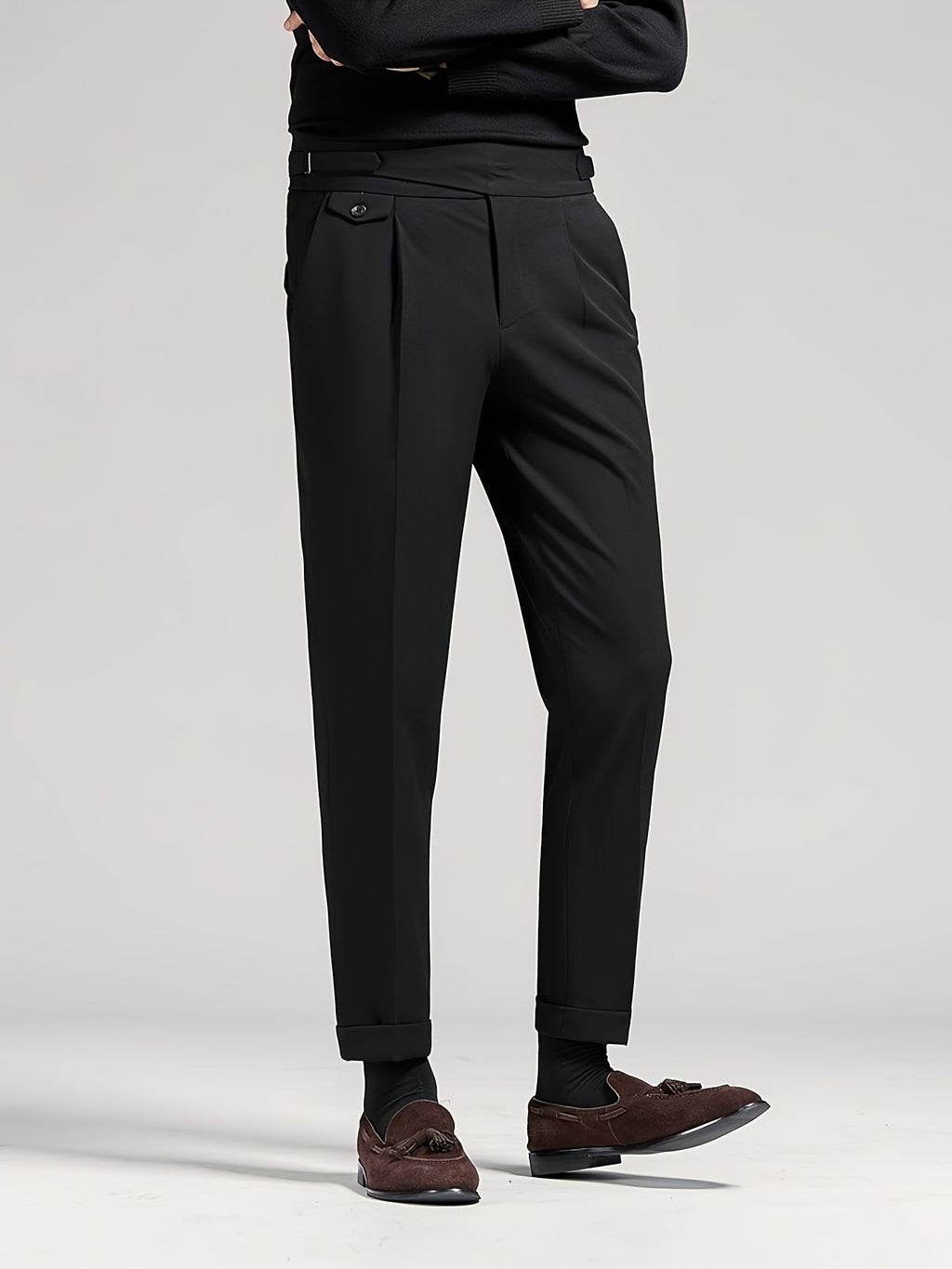 Men's black tailored pleated high-waist trousers, back view standing