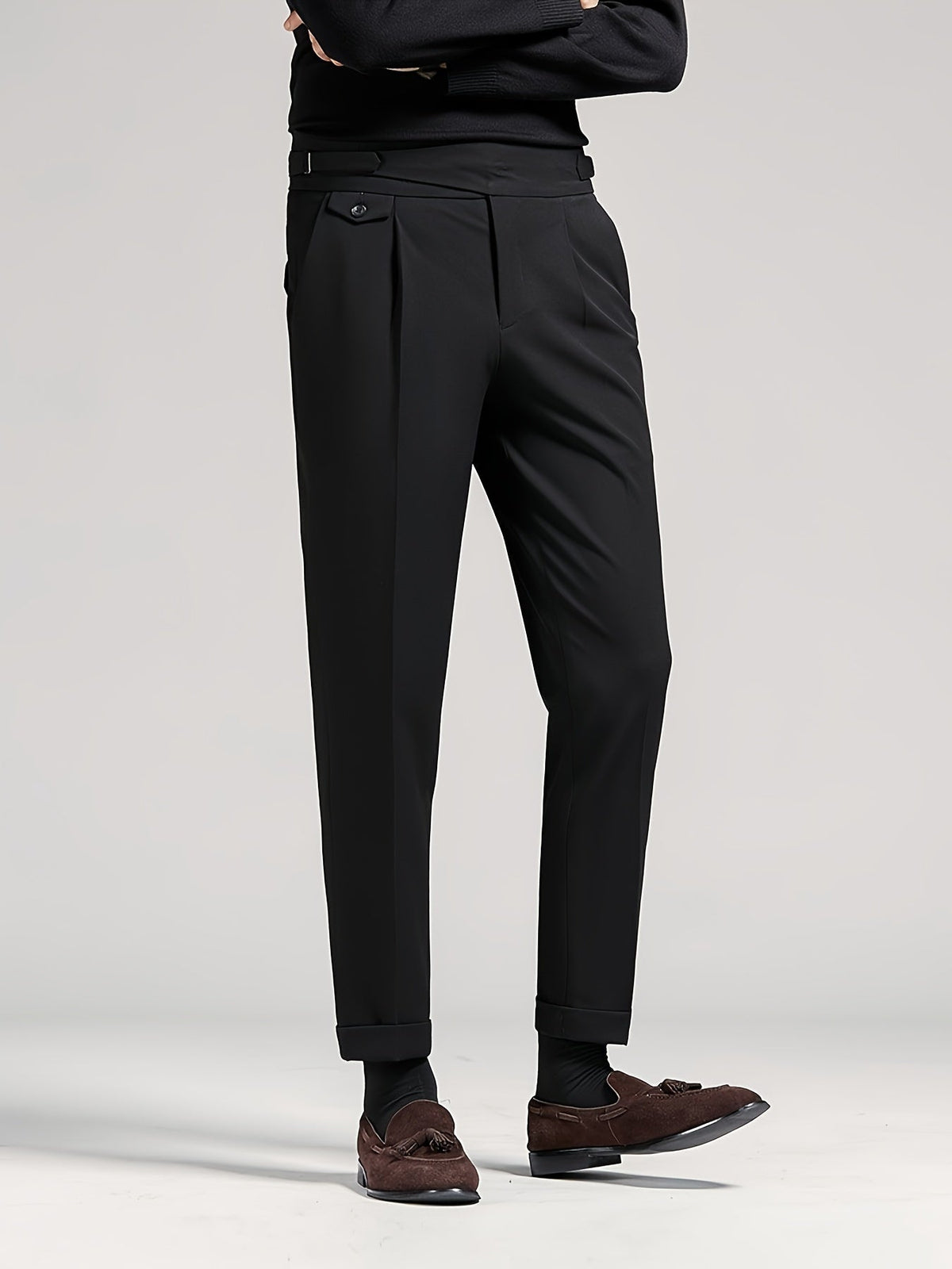 Men's black tailored pleated high-waist trousers, back view standing