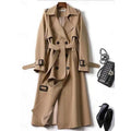 Women's khaki belted double-breasted trench coat with buckled cuffs