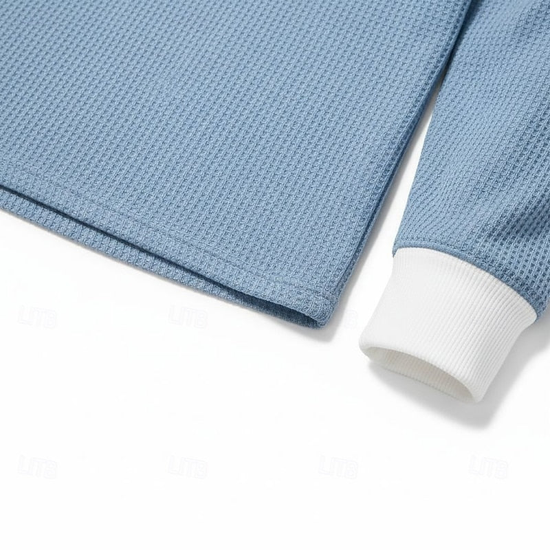 Men's light blue henley shirt, close-up of collar and buttons