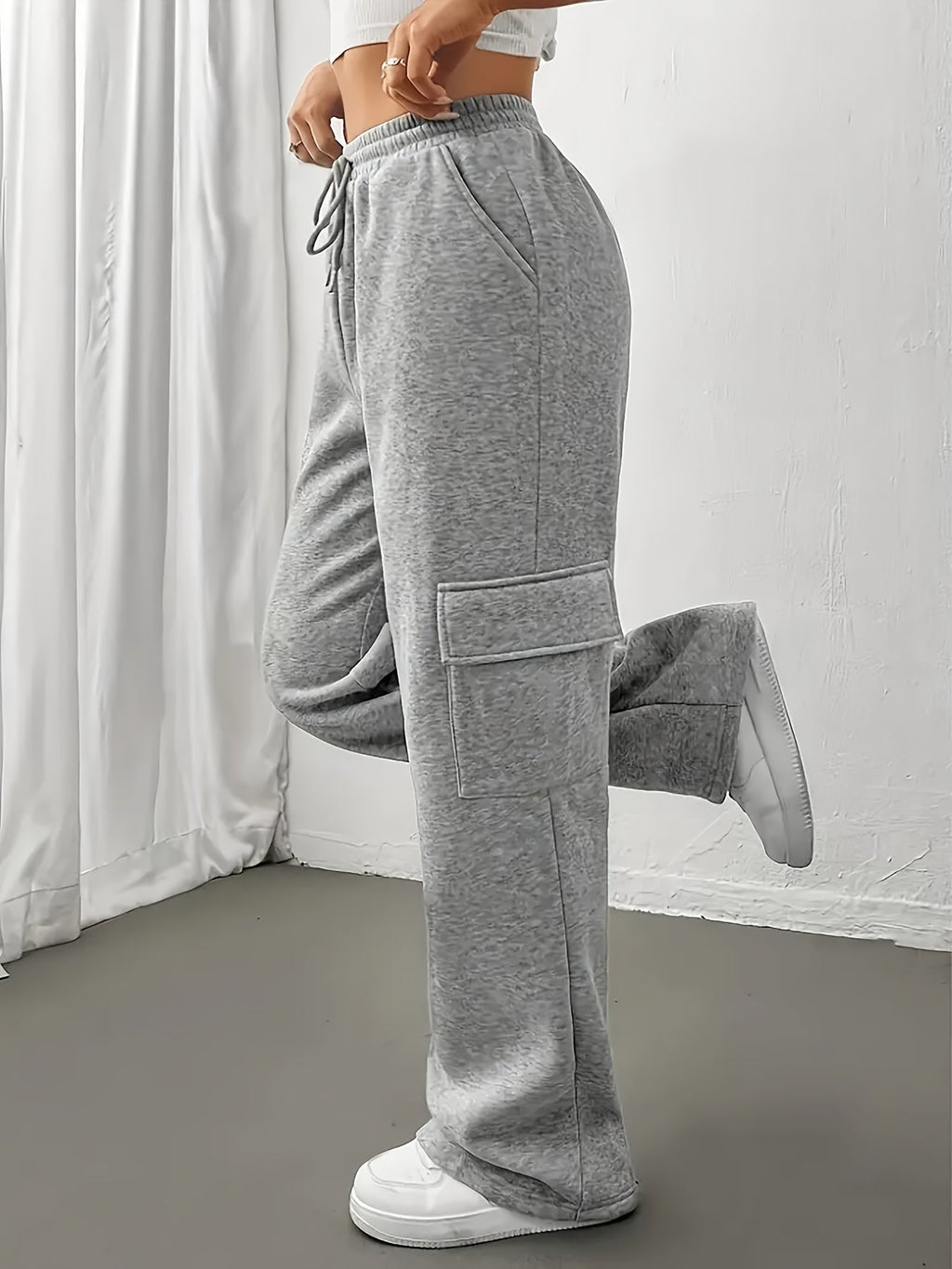 Women's grey cargo joggers, side view with cargo pocket detail