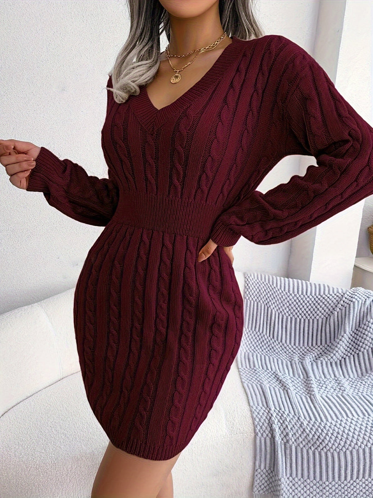 Women's black cable knit peplum sweater dress with V-neckline