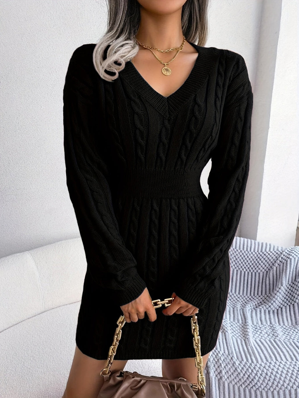 Women's black cable knit peplum sweater dress, side profile
