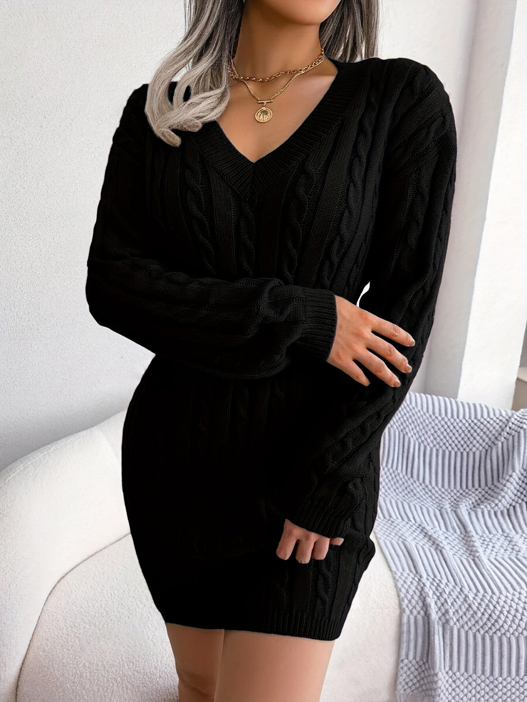 Women's black cable knit peplum sweater dress, side profile