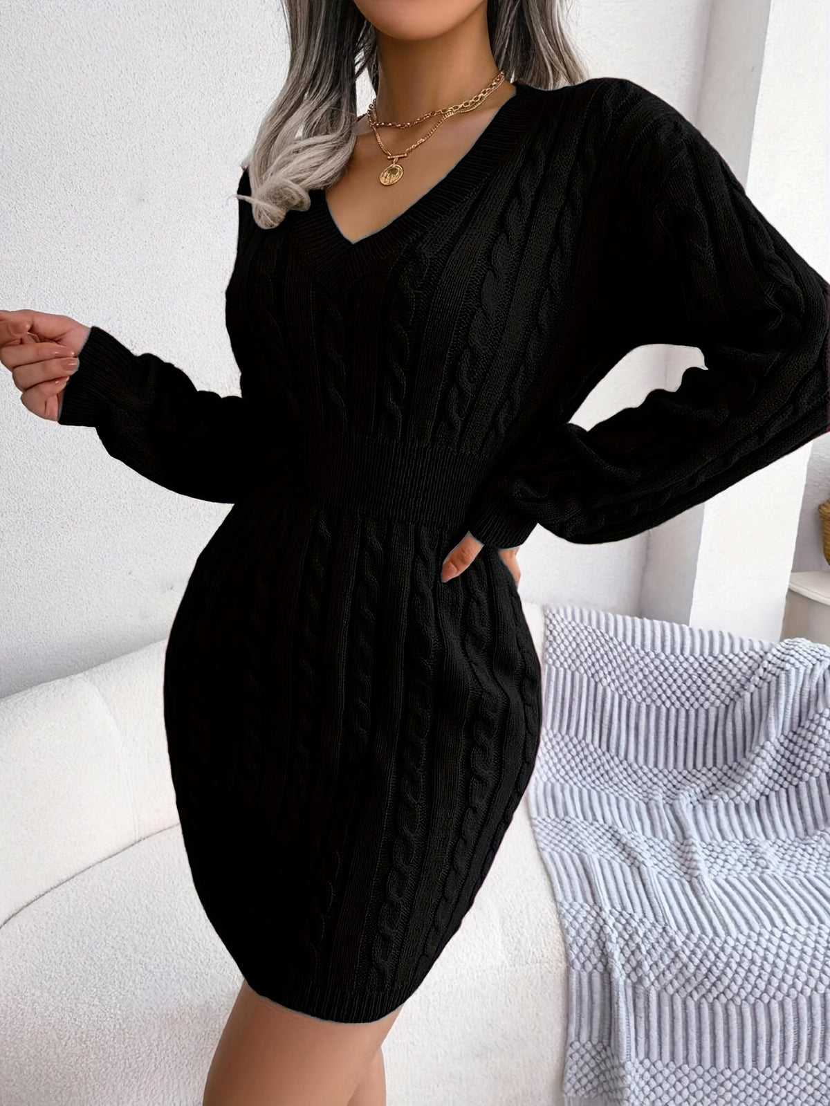 Women's black cable knit peplum sweater dress, side profile