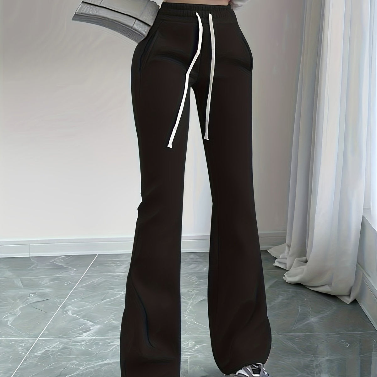 Women's black high-waisted flared lounge pants, back detail view