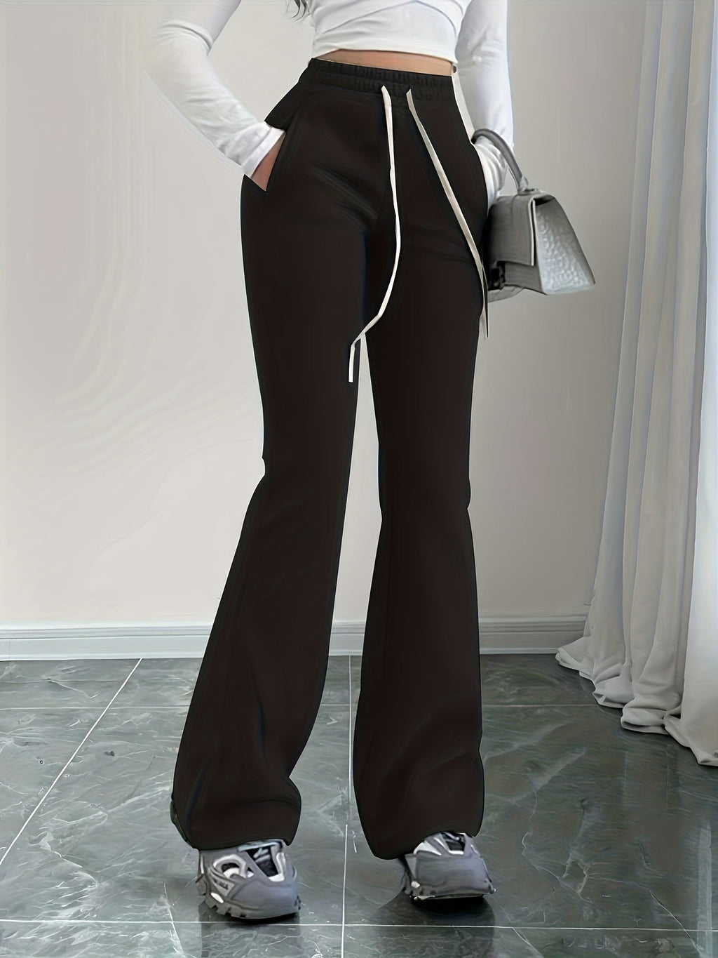 Women's black high-waisted lounge pants, back waistband detail