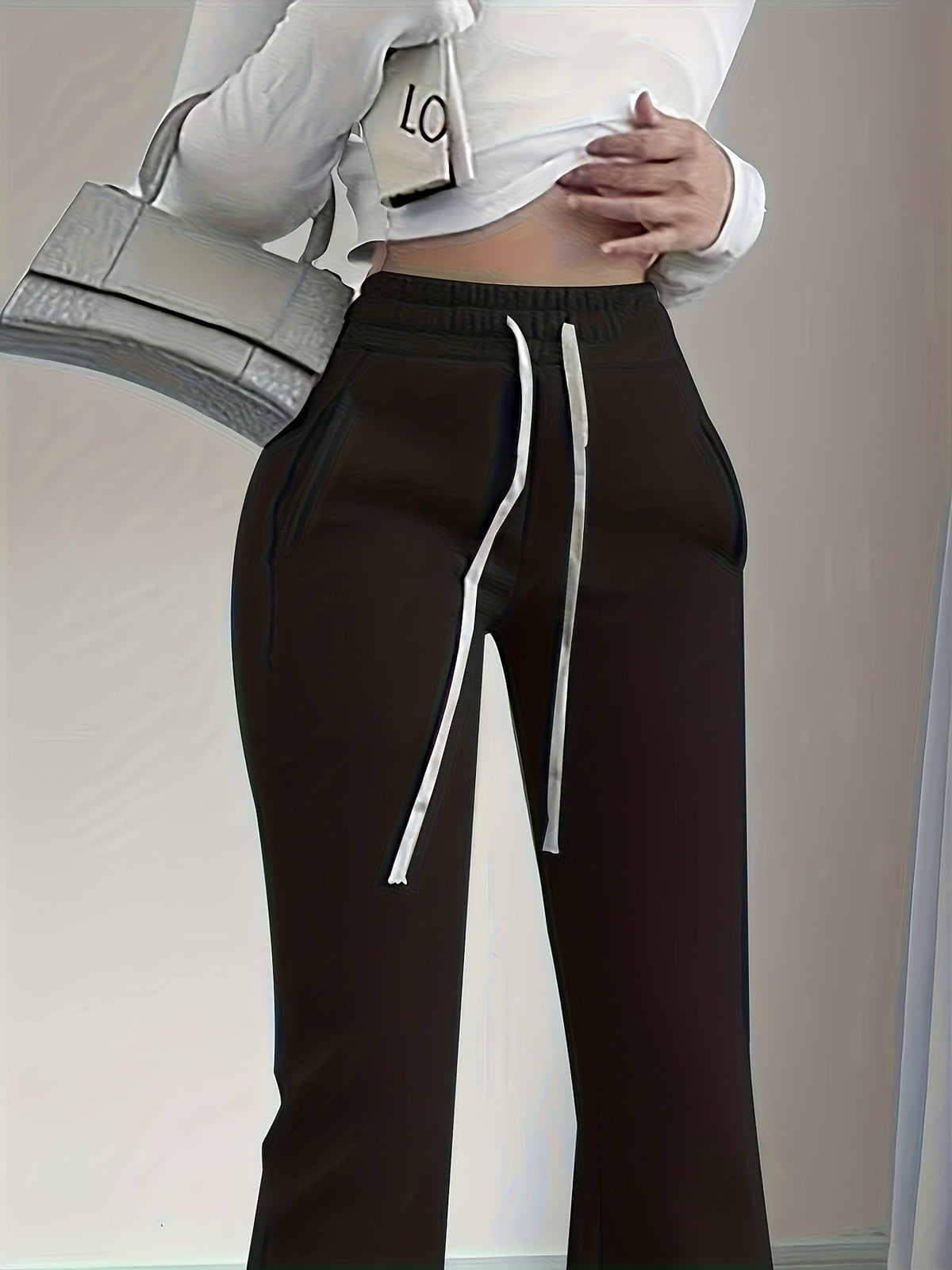 Women's black flared lounge pants, drawstring waist close-up