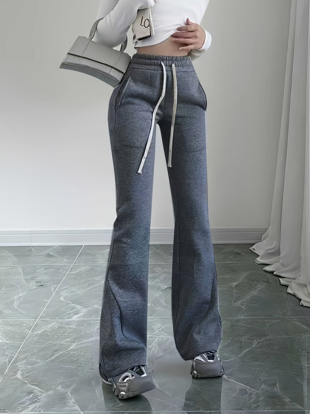 Women's black flared lounge pants, drawstring waist close-up