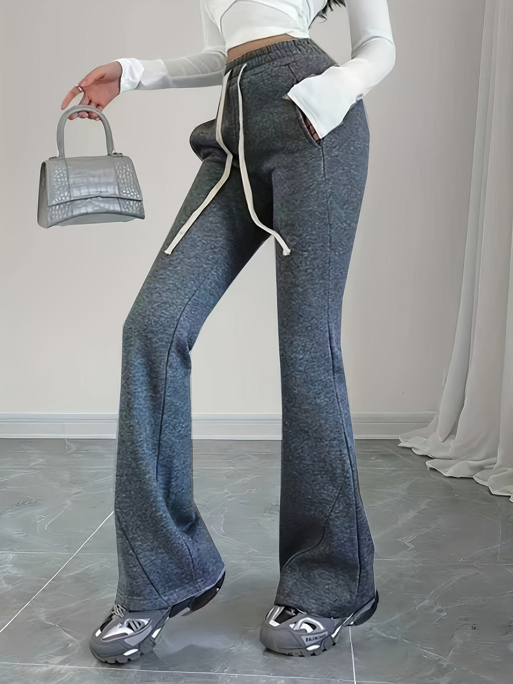 Women's black flared lounge pants, drawstring waist close-up