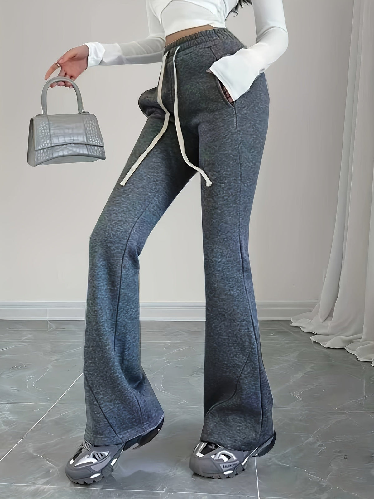Women's black flared lounge pants, drawstring waist close-up