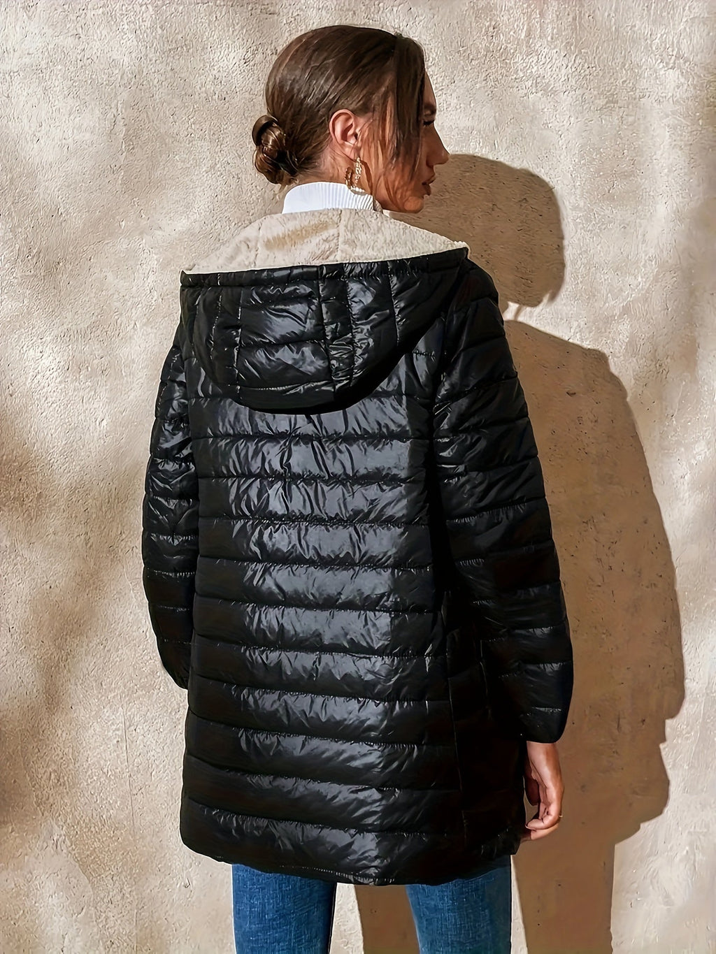 Women's quilted longline coat with a full zip and ribbed cuffs