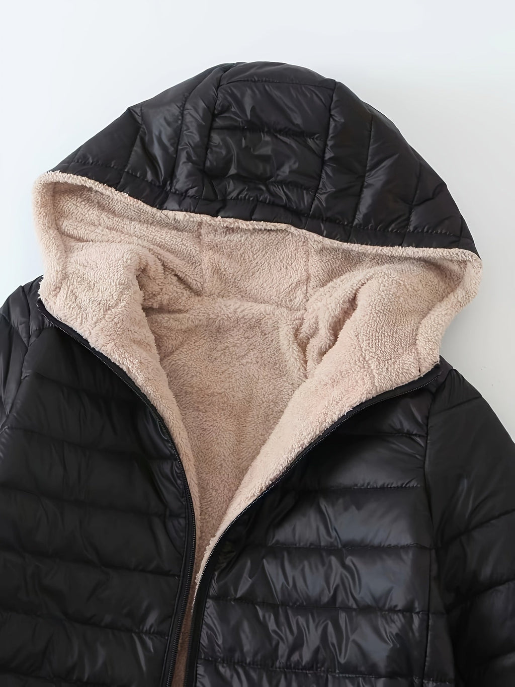 Women's quilted longline coat with a full zip and ribbed cuffs