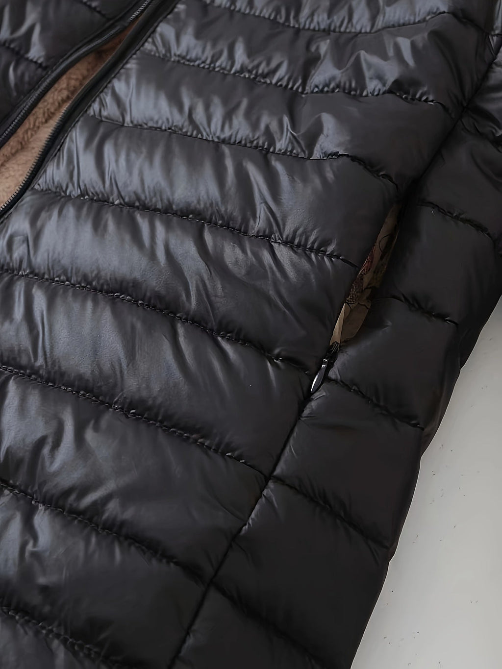 Women's quilted longline coat with a full zip and ribbed cuffs
