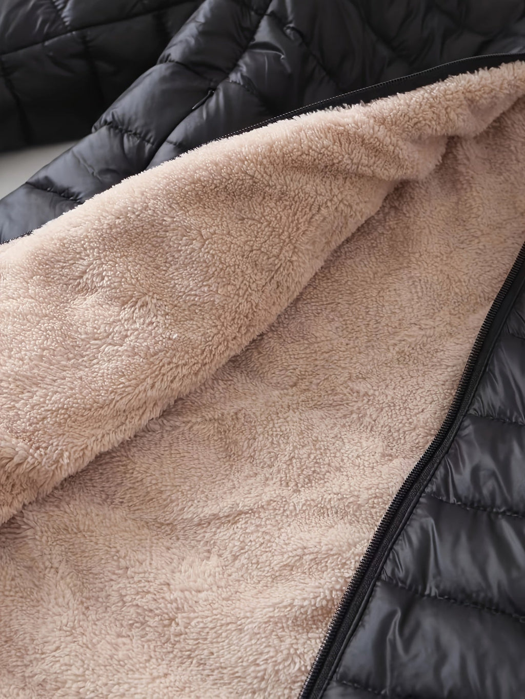 Women's quilted longline coat with a full zip and ribbed cuffs