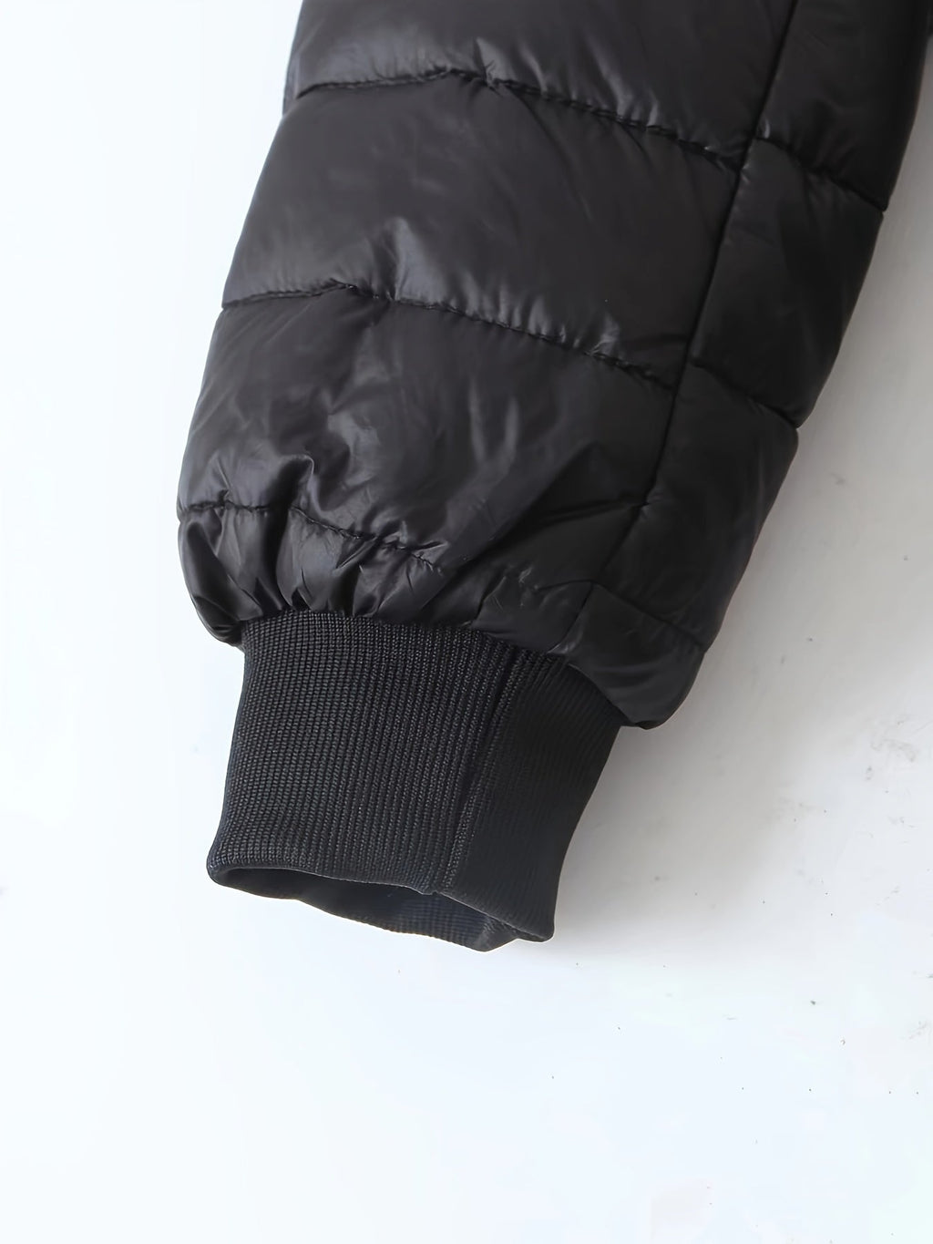 Women's quilted longline coat with a full zip and ribbed cuffs