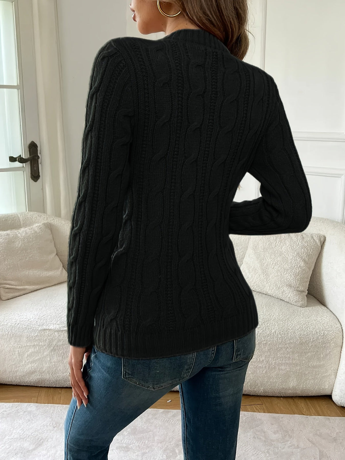 Women's black cable knit crew neck sweater with long sleeves