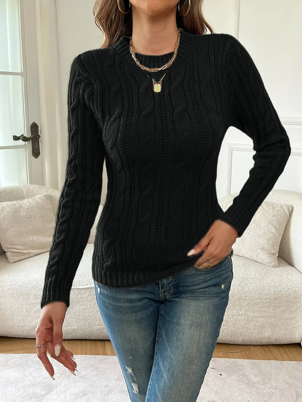 Women's black cable knit crew neck sweater with long sleeves