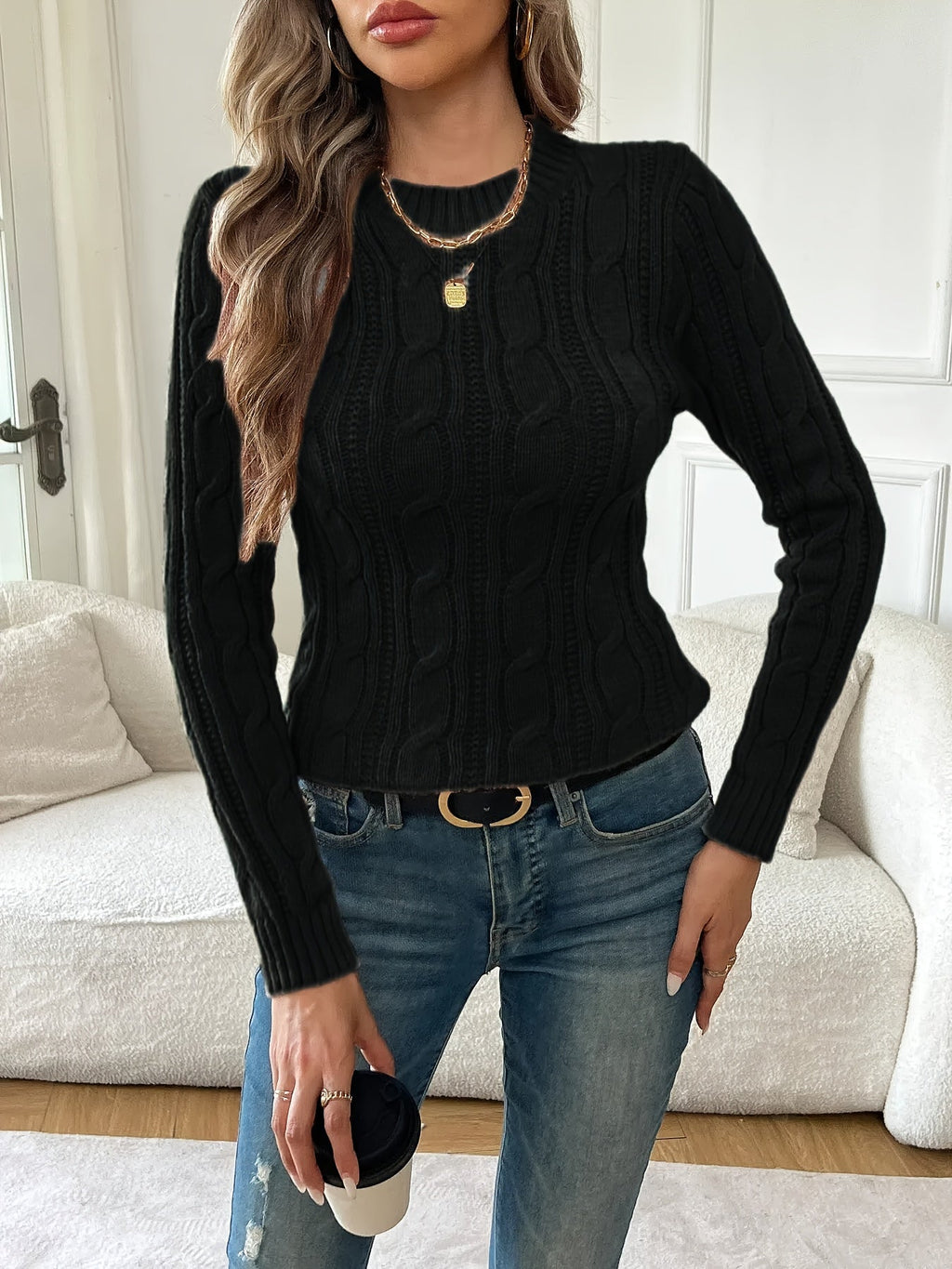 Women's black cable knit crew neck sweater with long sleeves