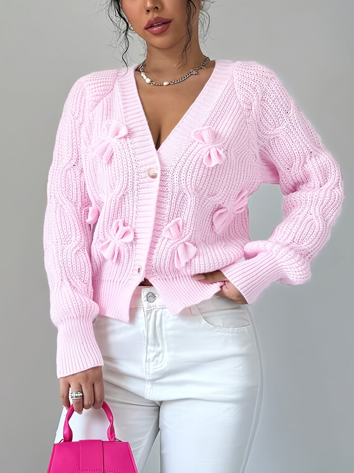 Women's pink bow-detail cardigan with long relaxed sleeves