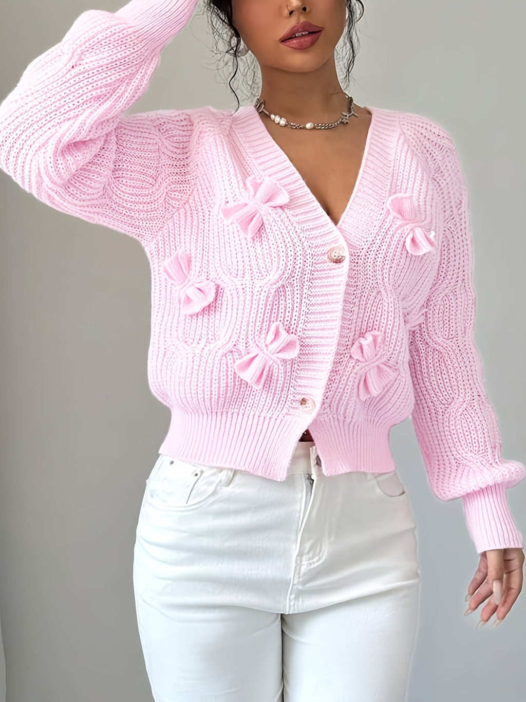 Women's pink bow-detail knit cardigan, front view