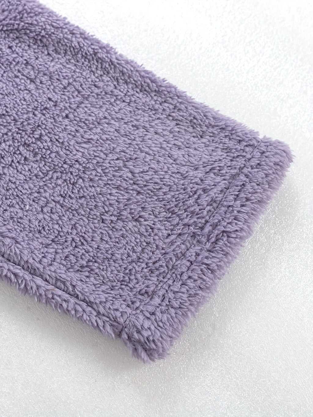 Women's purple fleece loungewear set, close-up of the ribbed hem