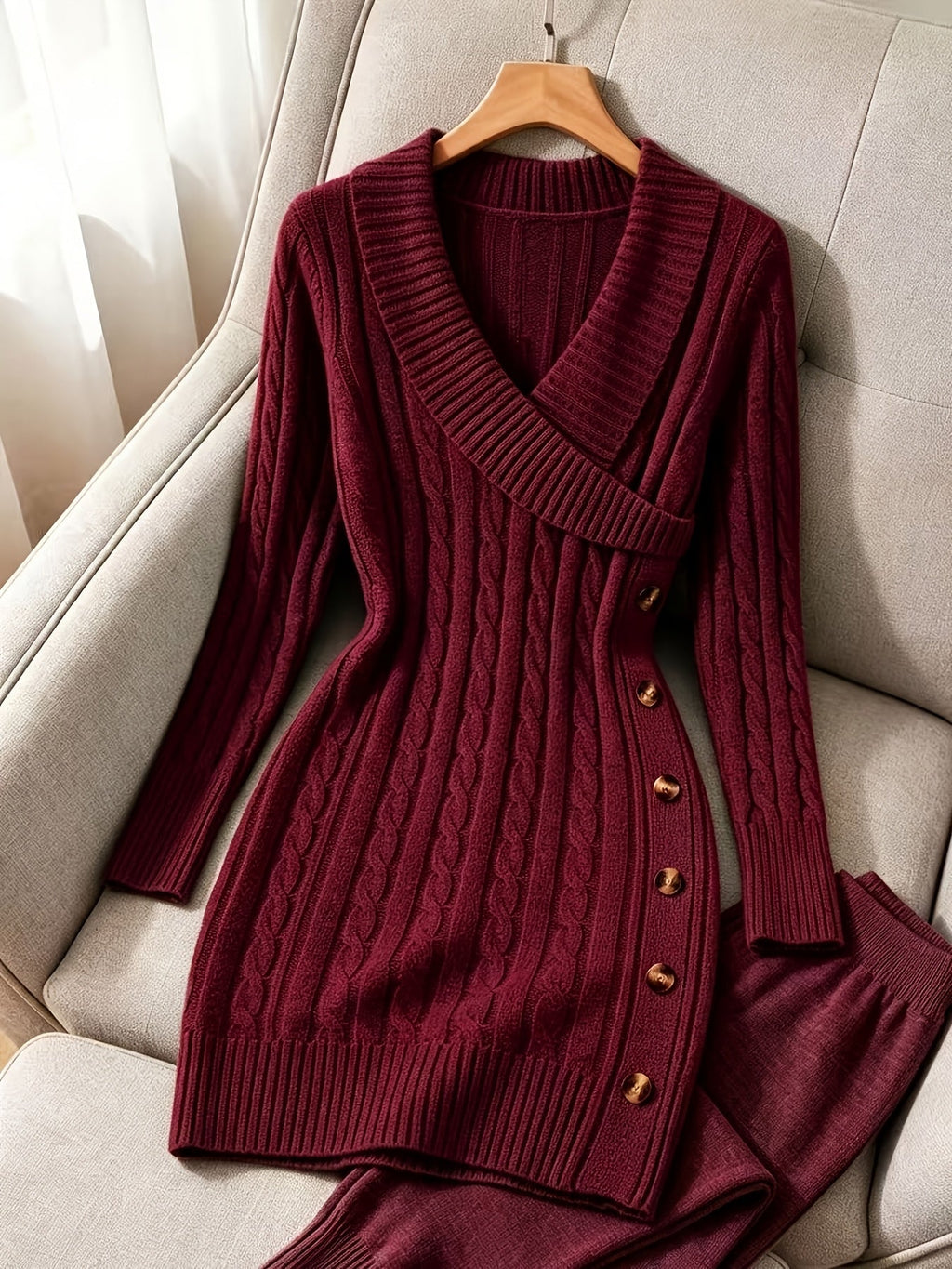 Women's burgundy cable knit sweater dress displayed on a hanger