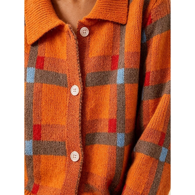 Close-up of the orange plaid cardigan's button-front detail