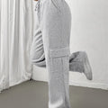 Women's light grey cargo joggers with side pockets and drawstring waist