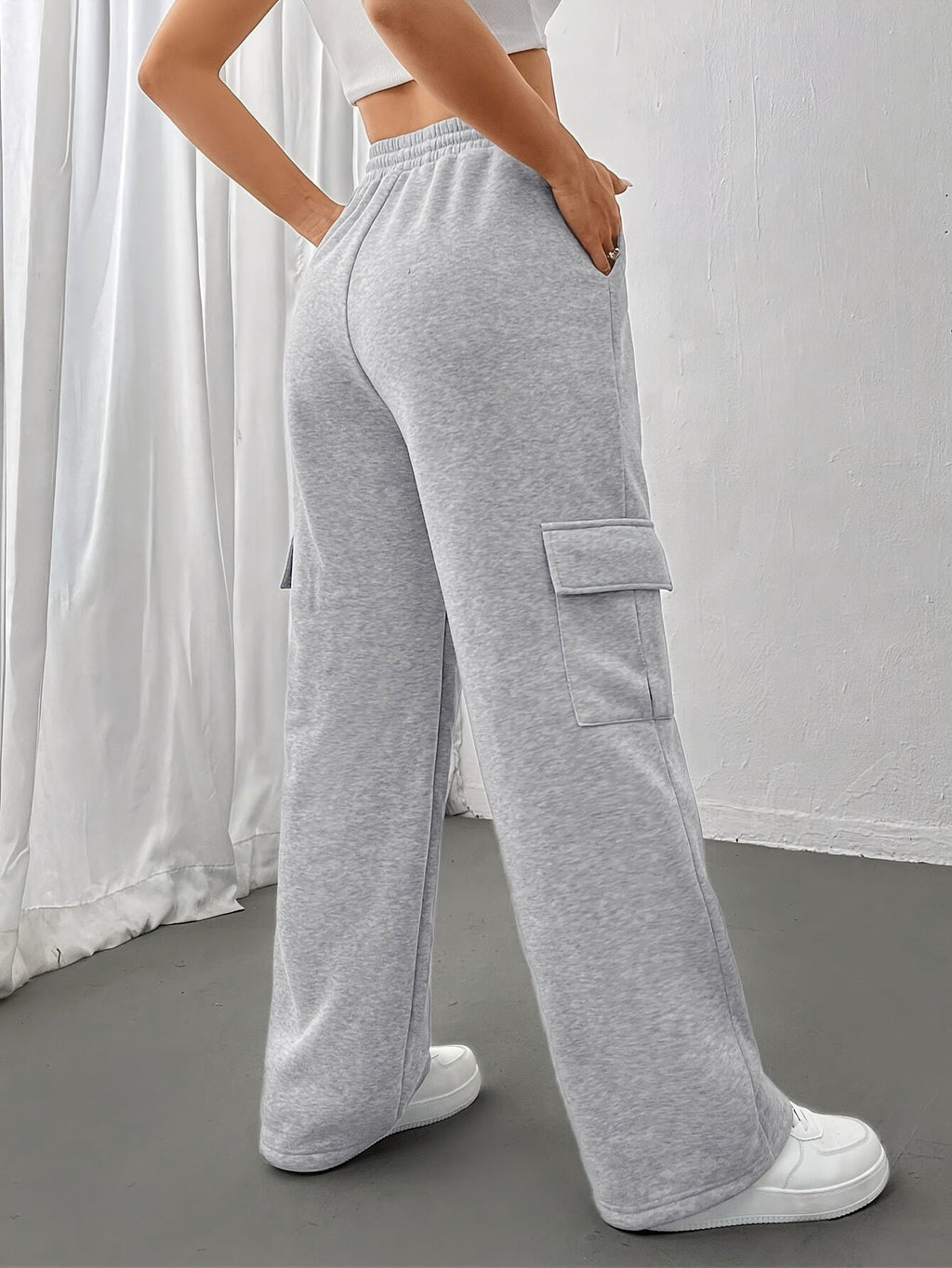 Women's light grey cargo joggers with side pockets and drawstring waist
