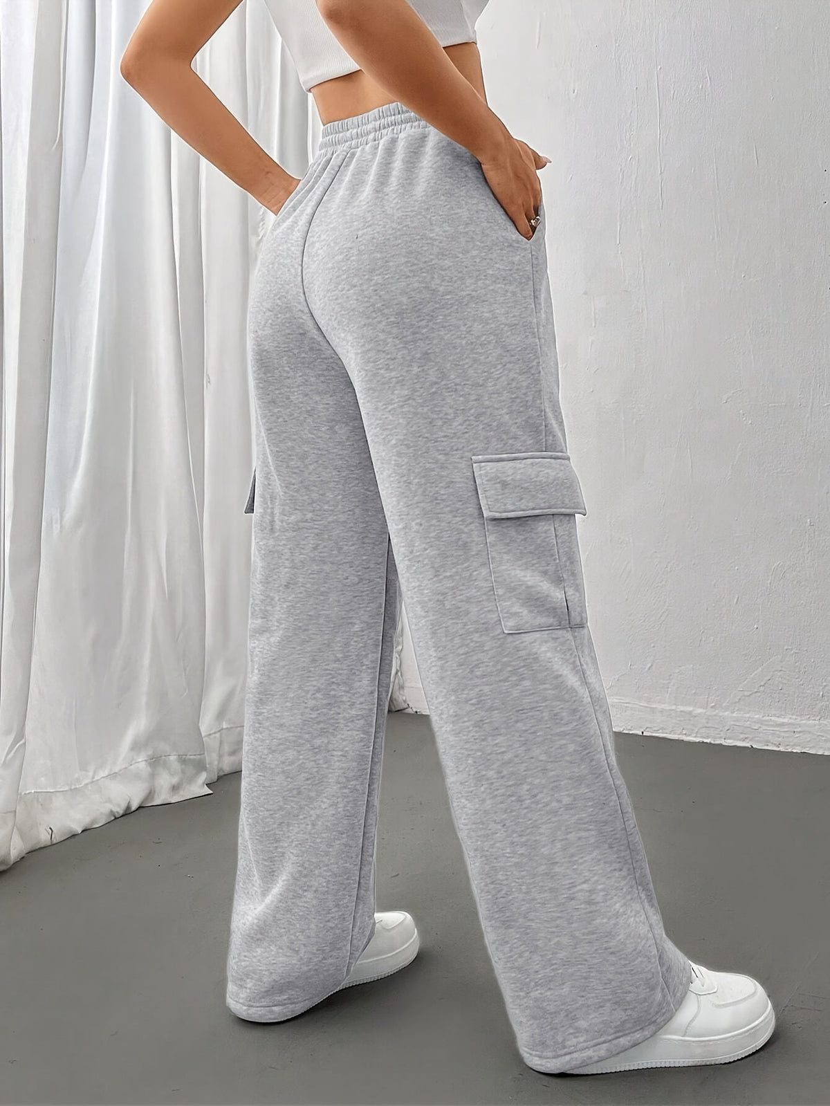 Women's light grey cargo joggers with side pockets and drawstring waist