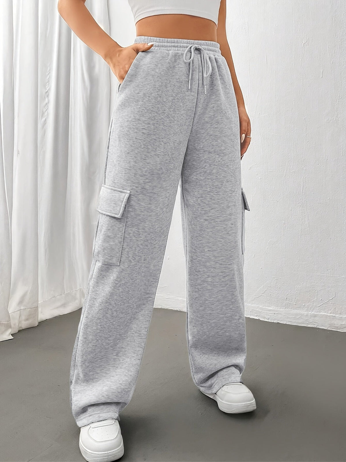 Women's light grey cargo joggers with side pockets and drawstring waist