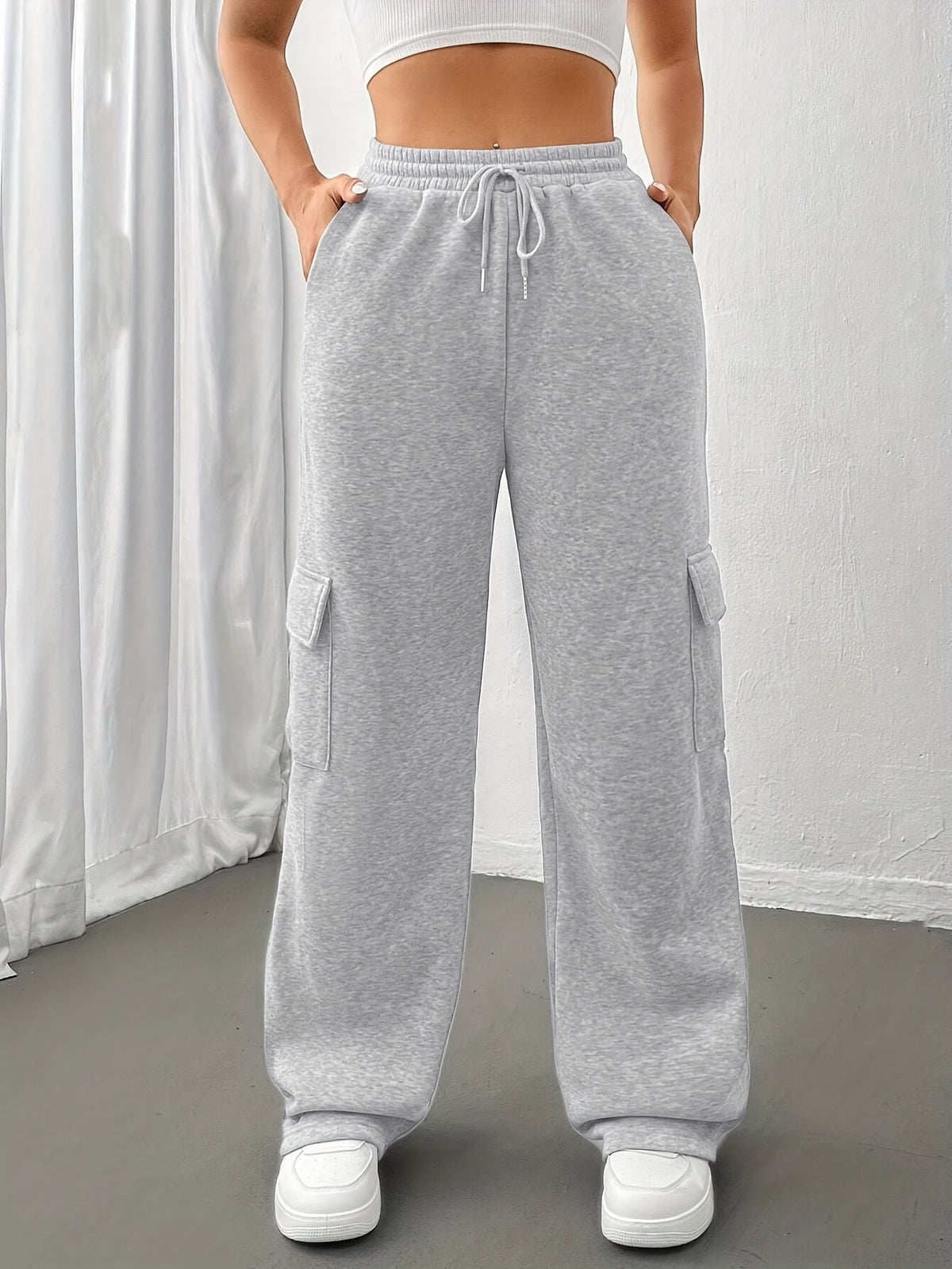 Women's light grey cargo joggers with side pockets and drawstring waist