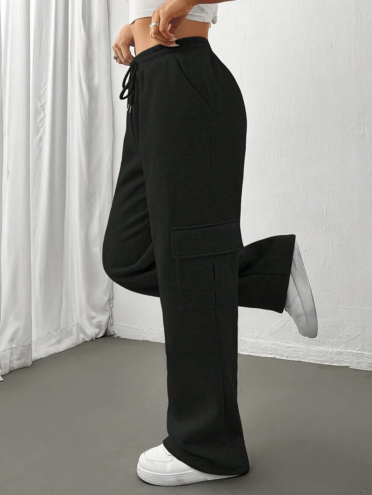 Women's light grey cargo joggers with side pockets and drawstring waist