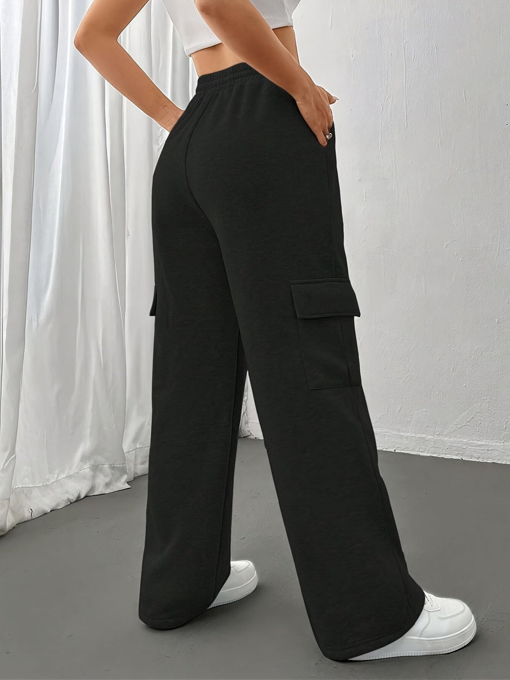 Women's light grey cargo joggers with side pockets and drawstring waist