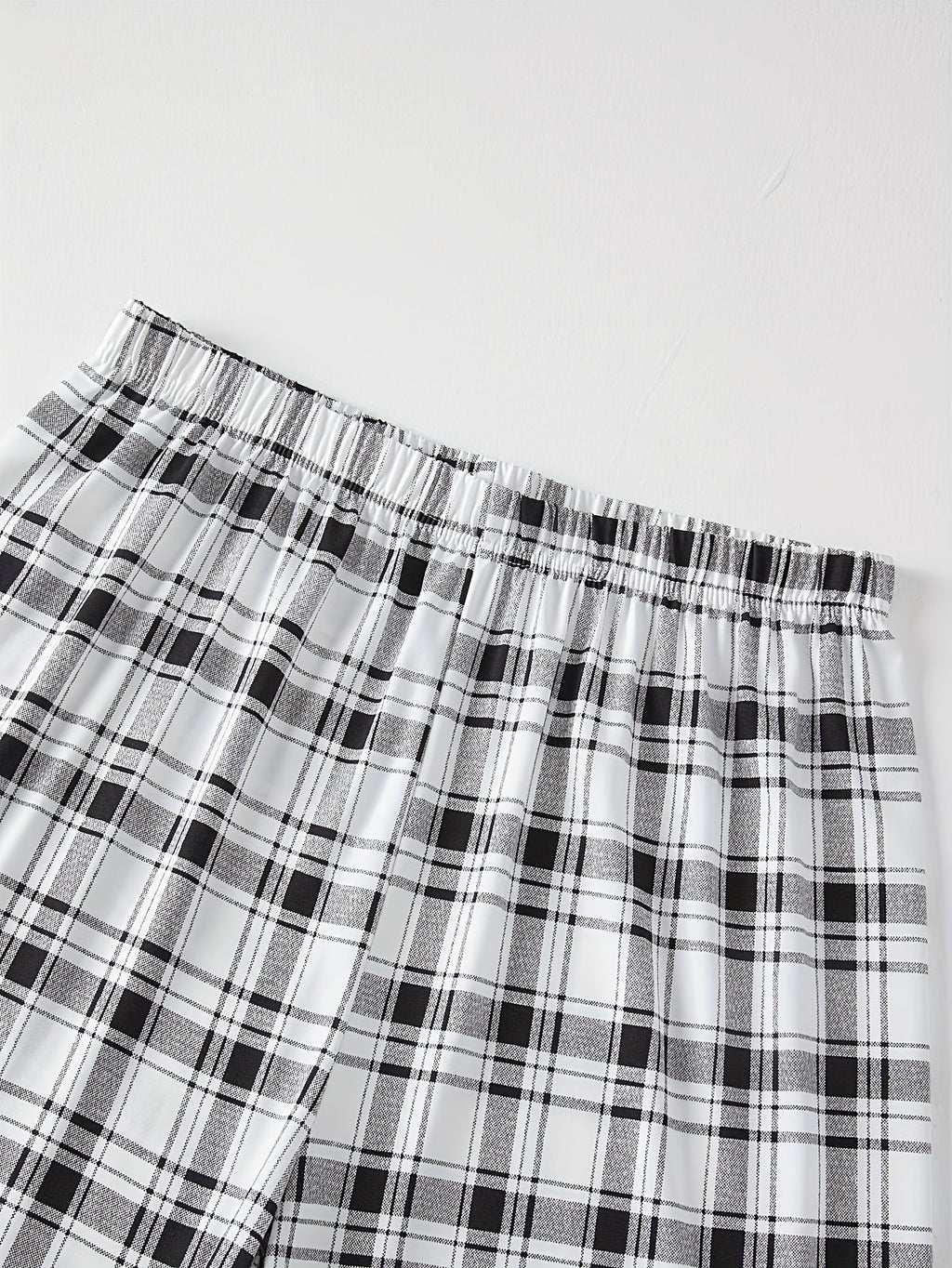 Men's light grey checkered two-piece pajama set with pocket tee
